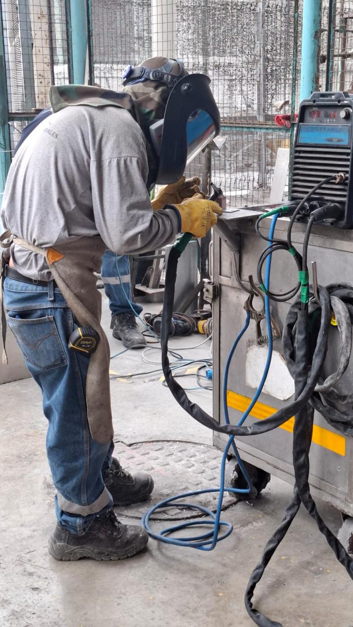 Soldadura de tubería sobre tanque industrial de acero inoxidable