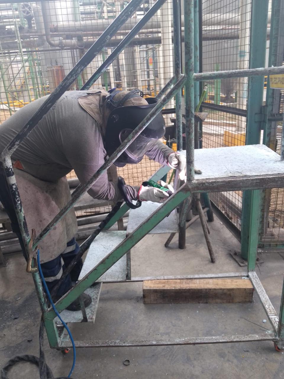 Operarios soldando y habilitando piezas industriales con chispas de corte